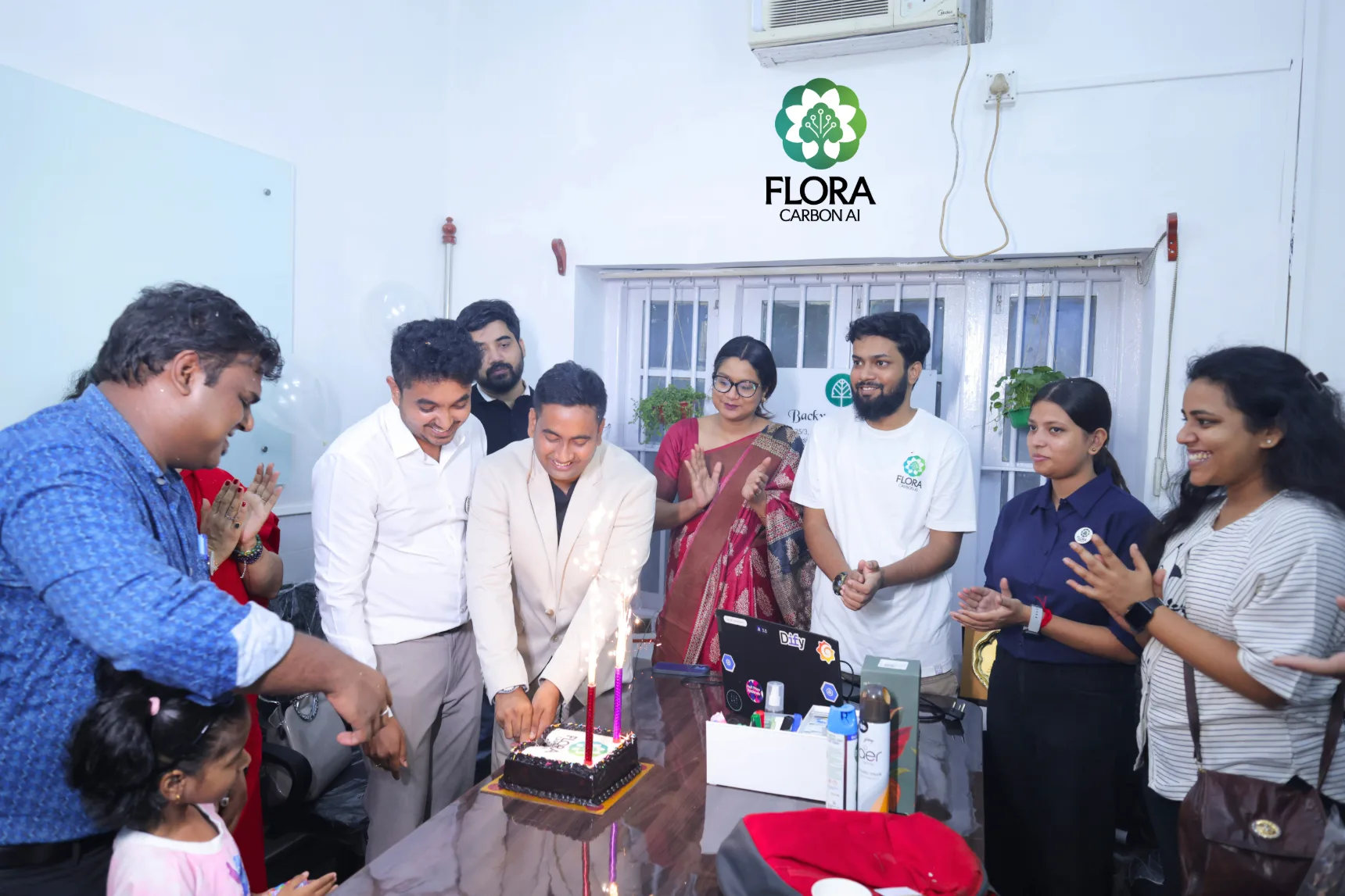 Flora Carbon AI team celebrating the office launch